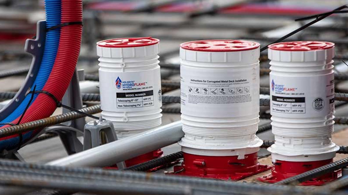 Firestop installation protecting pipe penetrations to prevent fire and smoke spread