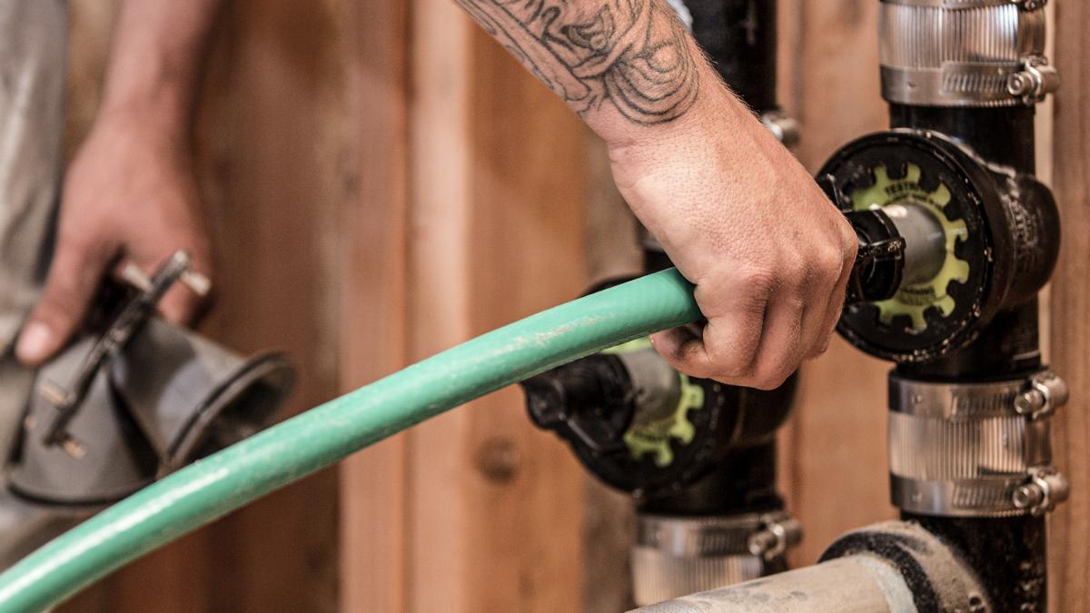 Plumber performing a DWV test with TestRite.