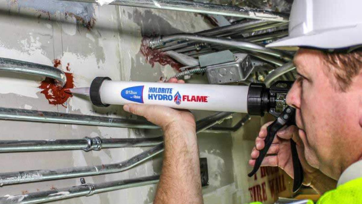 HoldRite firestop sealant application around plumbing penetrations for code compliance