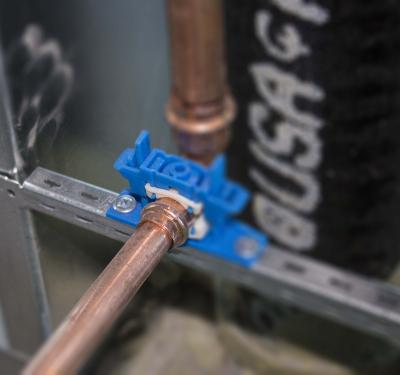 Silencer clamp on copper plumbing system.
