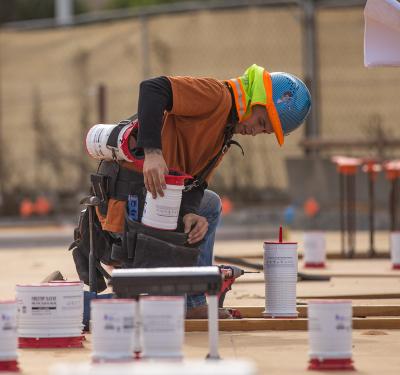 Commercial contractor installing HoldRite telescoping firestop sleeves
