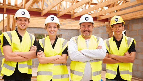 Plumbing professionals using HoldRite PEX stub-out supports on a jobsite