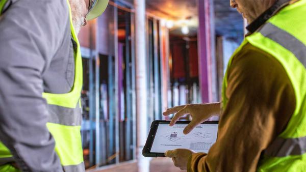 Plumbing engineer looks at spec sheet for firestop sleeve 