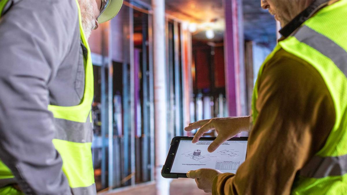 Plumbing engineer looks at spec sheet for firestop sleeve 