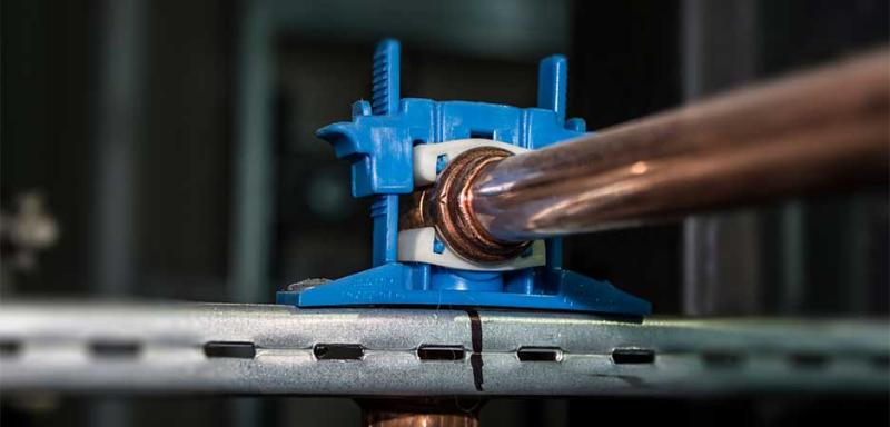 Acoustic pipe silencer mounted around copper pipe to reduce vibration and noise