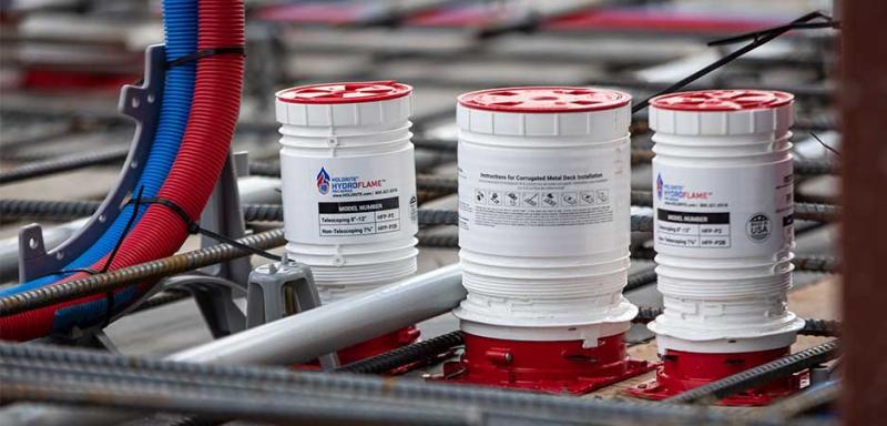 Firestop installation protecting pipe penetrations to prevent fire and smoke spread