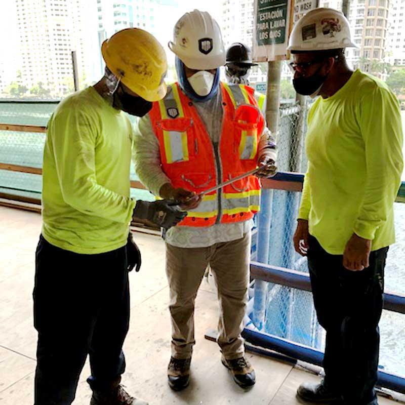 Plumbing professionals reviewing specifications and plans on a construction jobsite