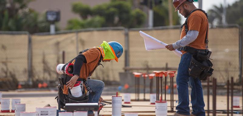Construction workers installing HoldRite HydroFlame Pro firestop products at a commercial  job site