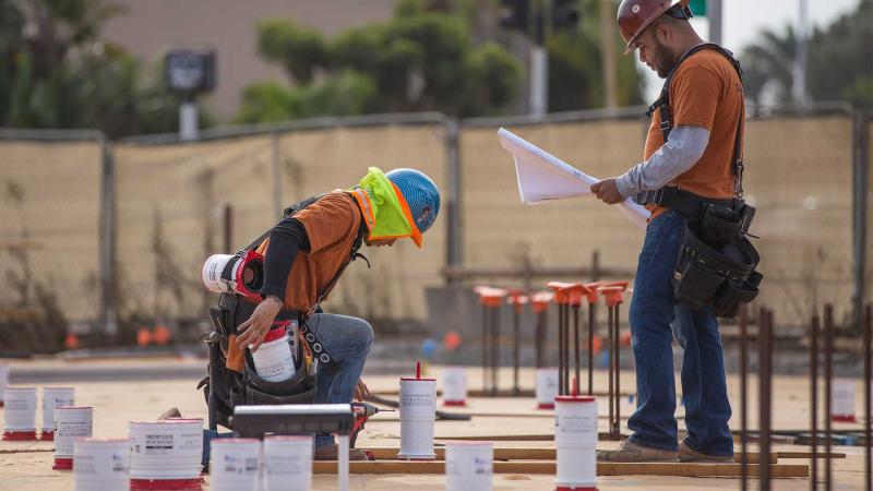 contractors installing firestop system on job site