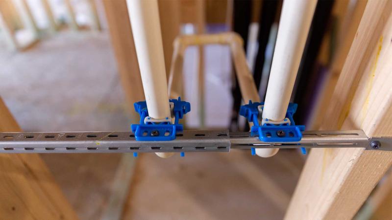 Plumbing engineer looks at spec sheet for firestop sleeve 