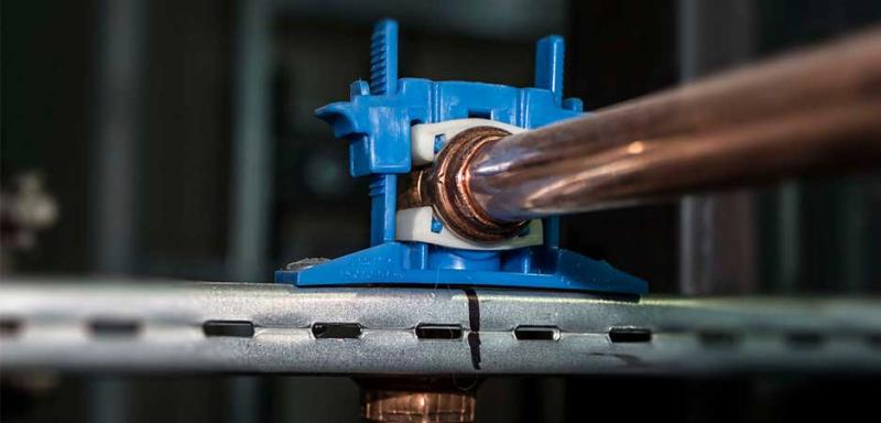Bracket and Silencer clamp installed on plumbing pipe for secure support and vibration reductio